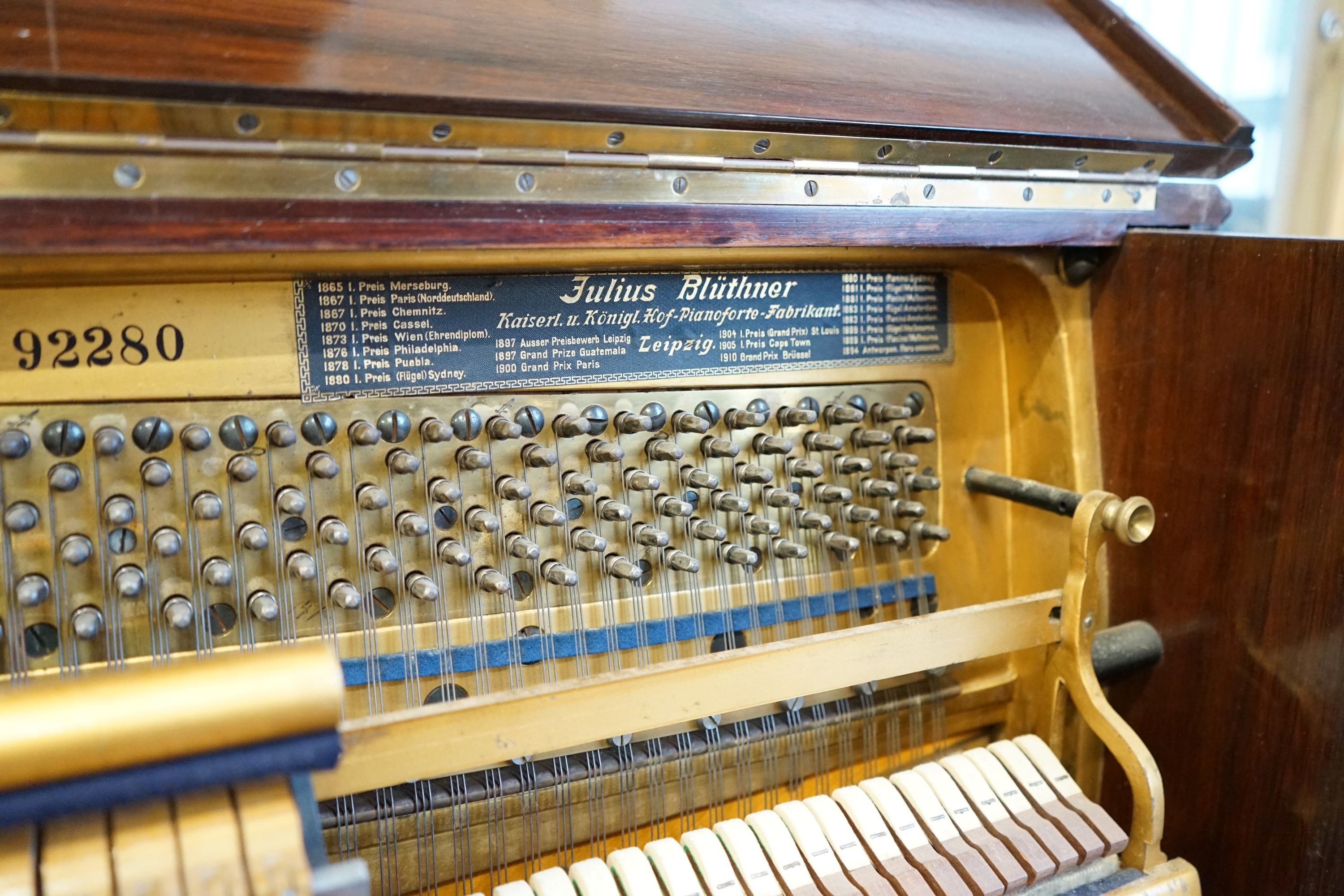 An early 20th century walnut cased Bluthner upright piano, Serial Number 92280